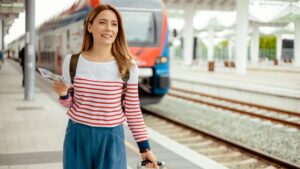 駅のホーム赤いストライプ柄一人旅の女性